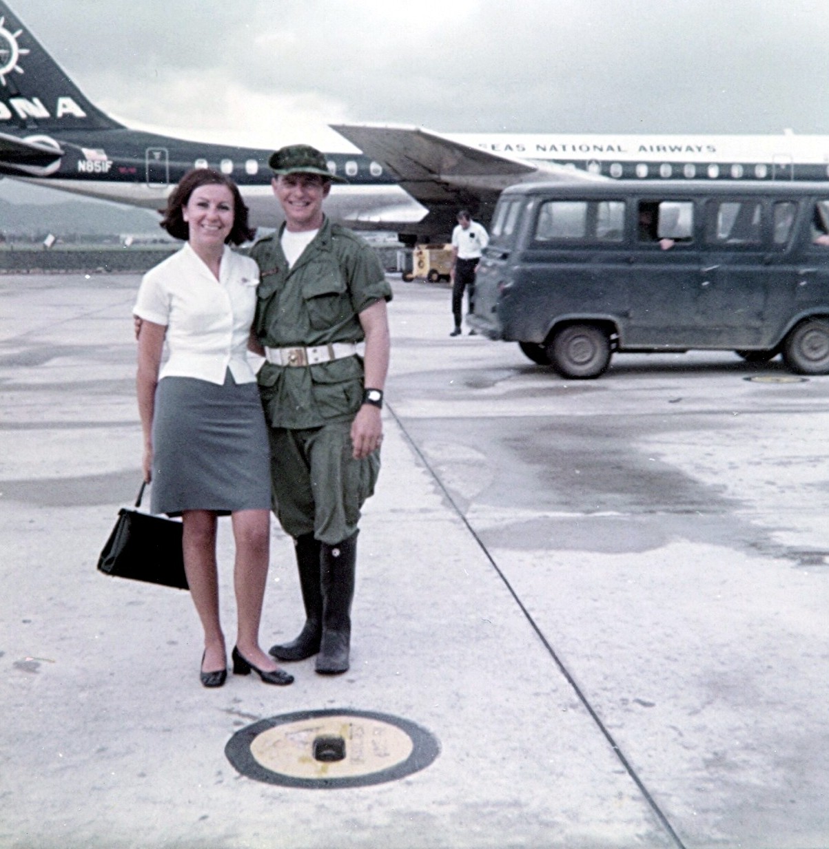 1968 DaNang, Vietnam, Pan Am Flight Attendant, Maureen VanLeeuwen, poses with an Australian soldier with an Overseas National Airways DC8 in the background.